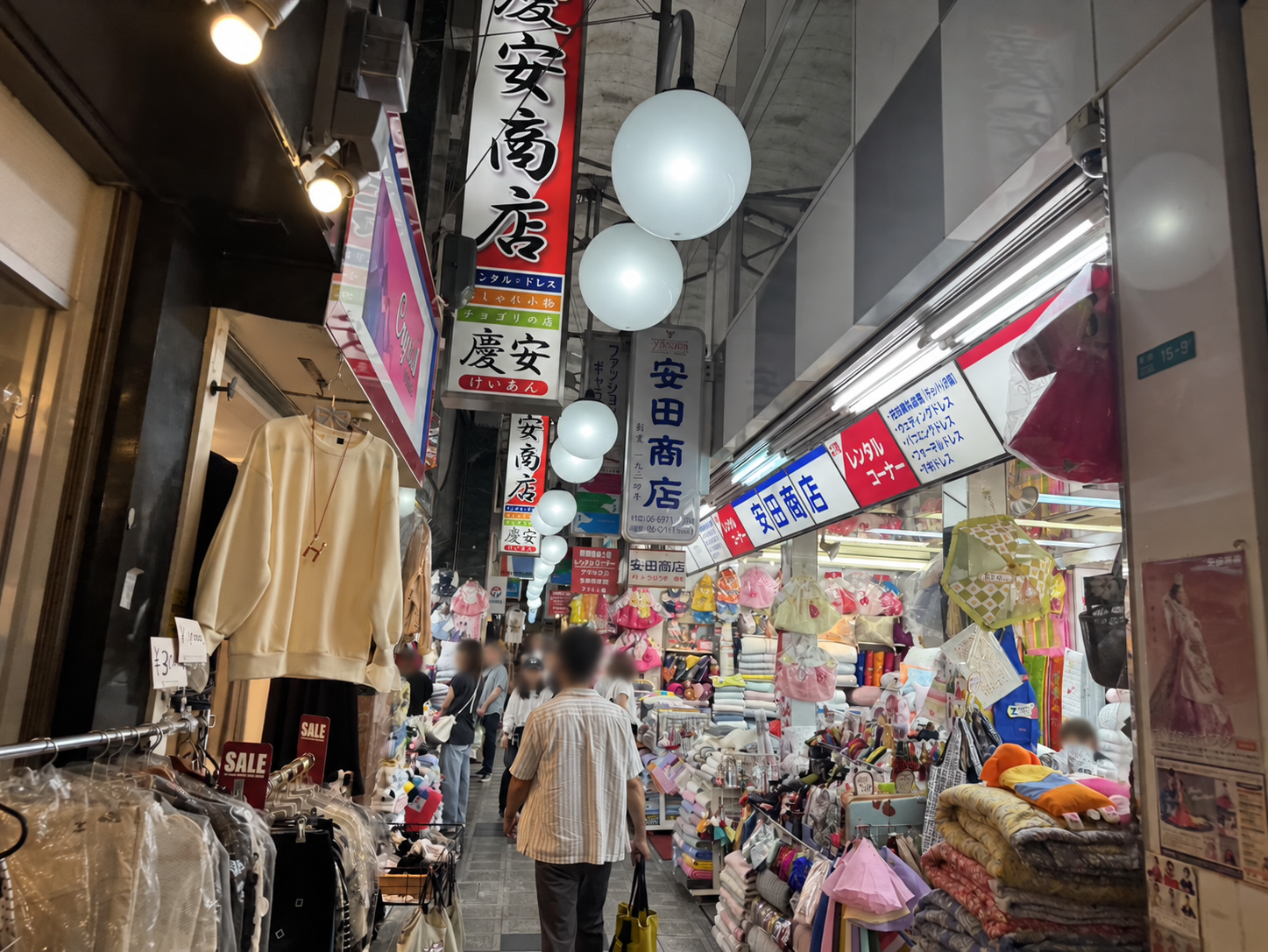 衣料品店が並ぶ商店街と、通りを歩く人たち